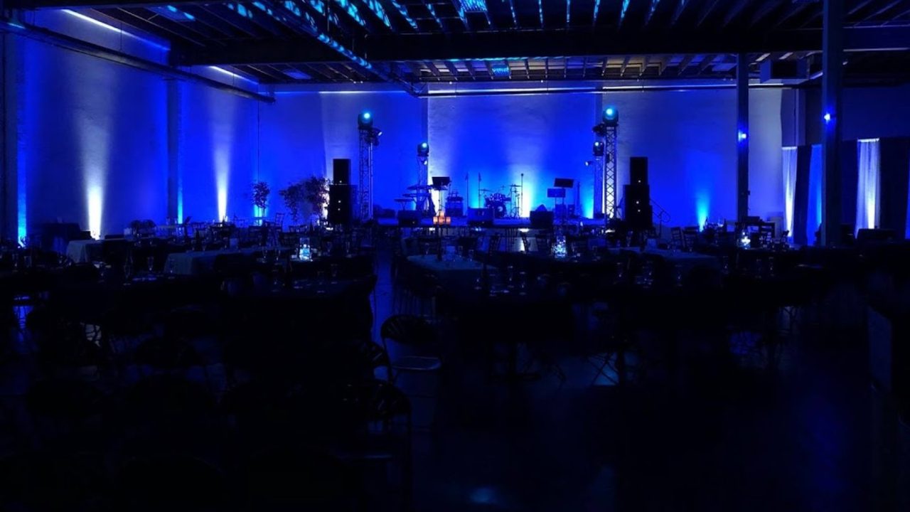 Concert-style stage with line array and uplight wash
